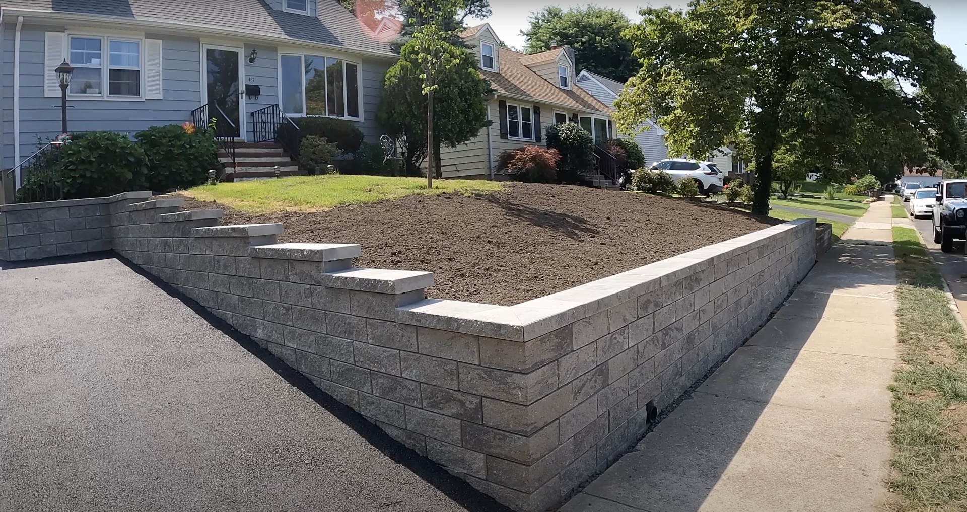 Concrete retaining wall construction project in residential neighborhood