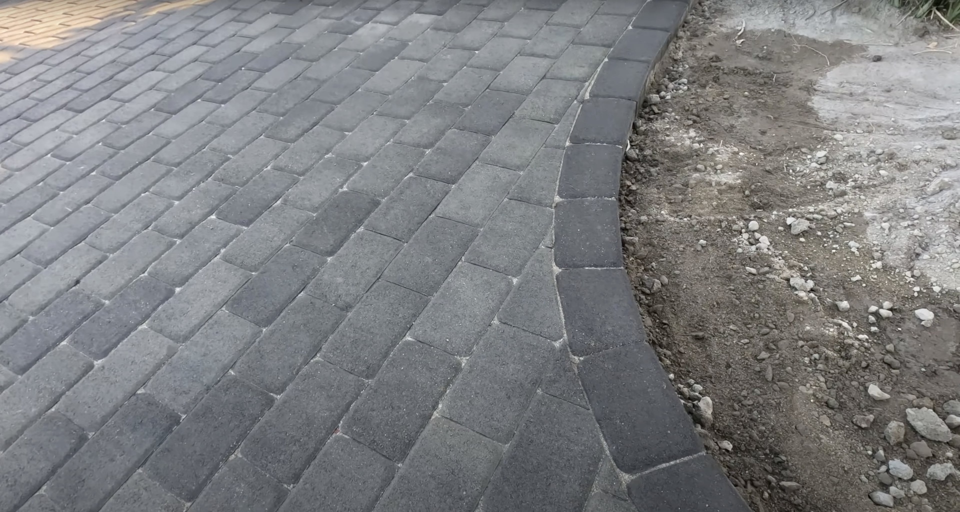 Concrete paver installation project showing precision workmanship