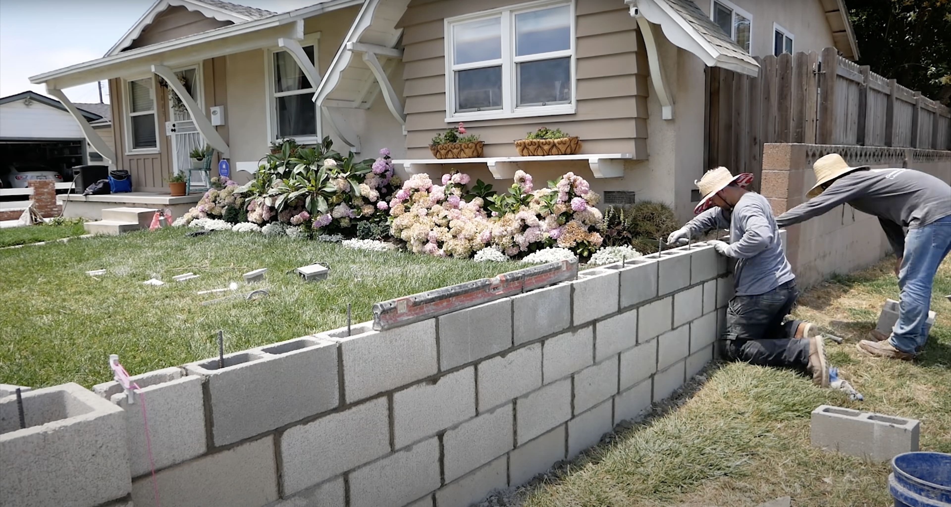 Professional concrete contractors building retaining wall for residential property