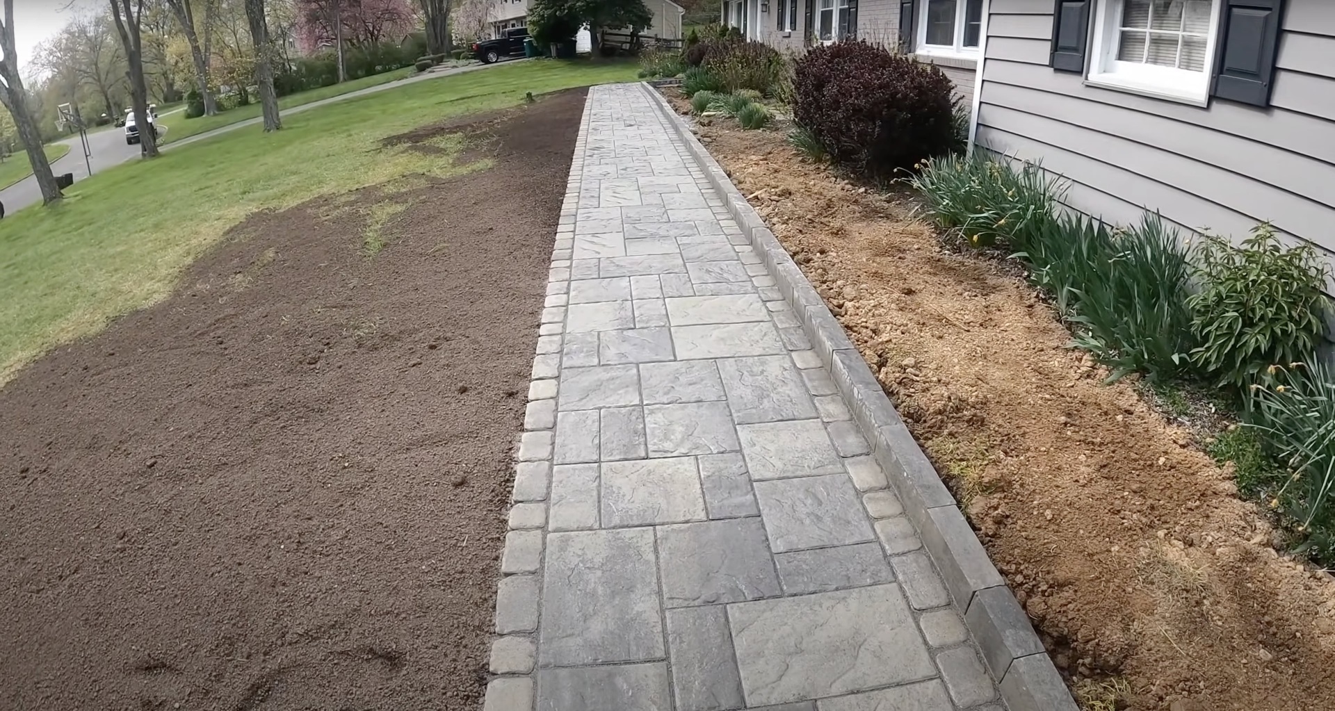Stamped concrete walkway with decorative border pattern