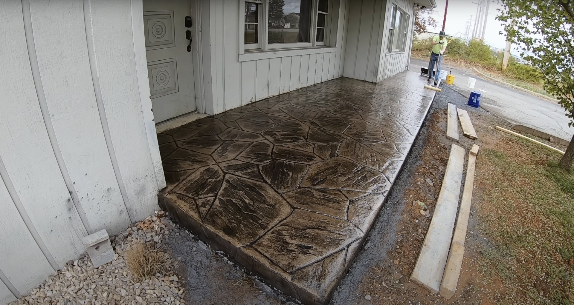 Stamped concrete patio installation with decorative stone pattern